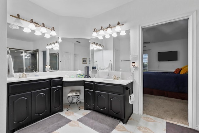 bathroom with an enclosed shower, vanity, and tile patterned flooring