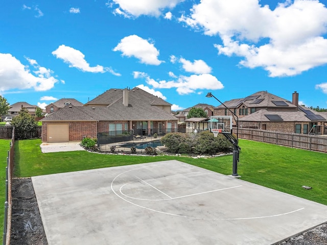 view of sport court featuring a lawn, a residential view, fence, and basketball hoop