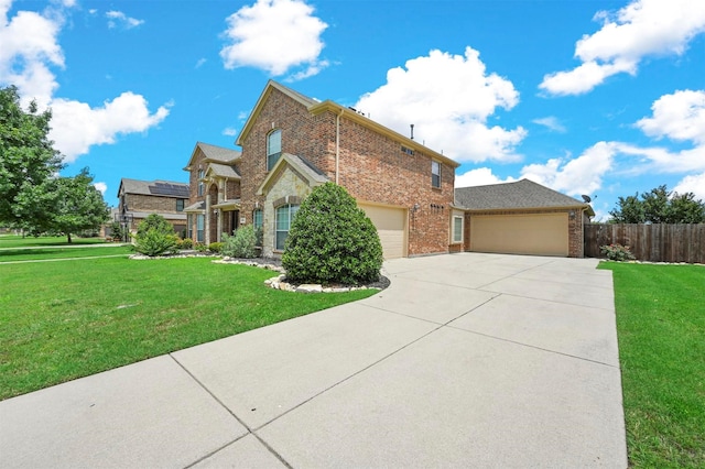 traditional home with fence, driveway, a front lawn, and brick siding