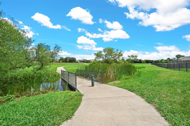 view of home's community with a yard and a water view