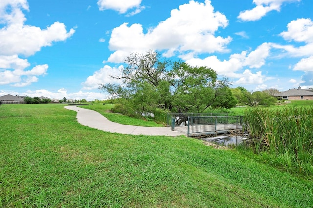 view of property's community with a lawn