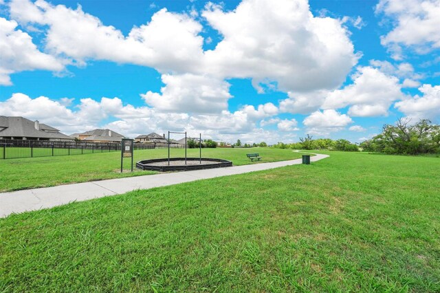 surrounding community featuring a lawn and fence