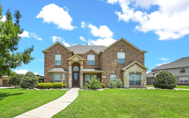 traditional-style house featuring brick siding and a front yard