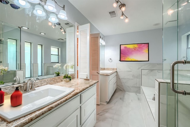 bathroom with vanity and a shower with door