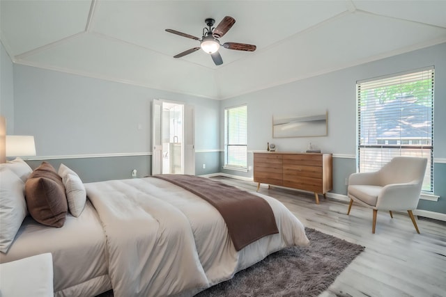 bedroom with ensuite bathroom, a raised ceiling, ceiling fan, light hardwood / wood-style floors, and lofted ceiling