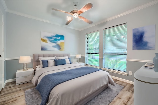 bedroom with ceiling fan, light wood-type flooring, and ornamental molding