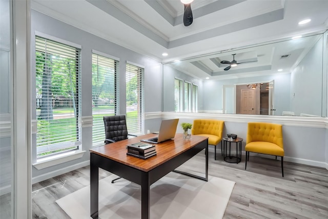 office area featuring ceiling fan, a raised ceiling, ornamental molding, and light hardwood / wood-style flooring