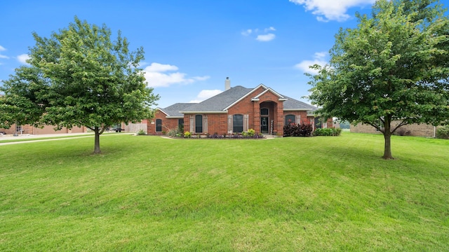 5333 Tree Grace Ln, Kaufman, TX 75142 - view of front of property with a chimney, a front yard, and brick siding
