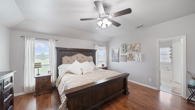 bedroom featuring connected bathroom, ceiling fan, multiple windows, and dark hardwood / wood-style floors