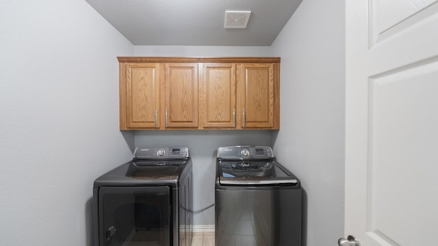 laundry area with cabinets and independent washer and dryer