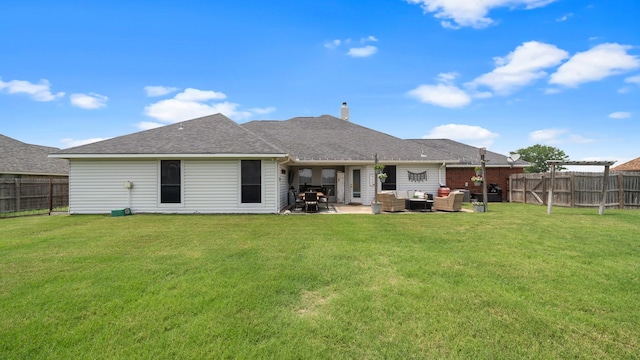 back of property with a lawn, an outdoor living space, and a patio