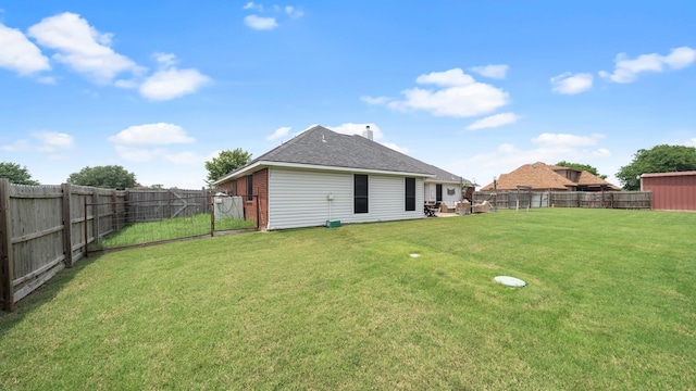 back of house with a lawn