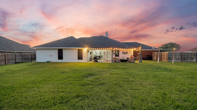 back house at dusk with cooling unit, a lawn, outdoor lounge area, and a patio area