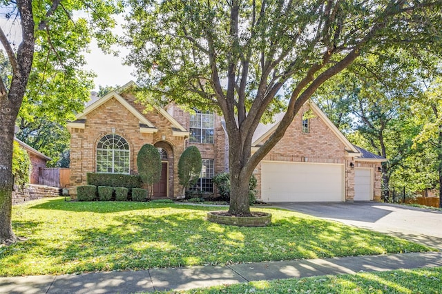 view of front of property featuring a garage and a front lawn