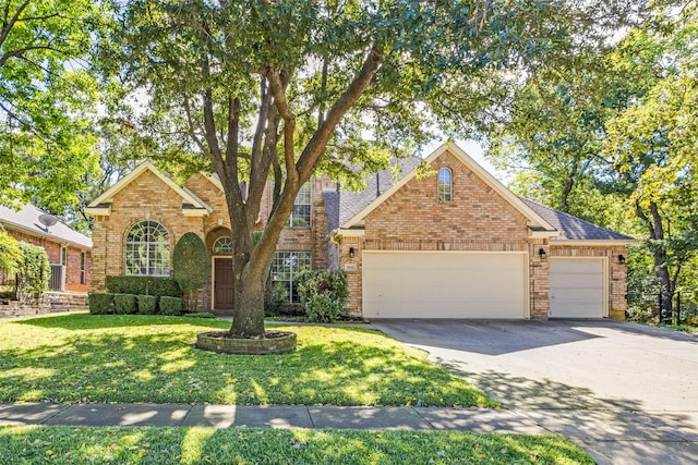 view of front property featuring a garage and a front lawn