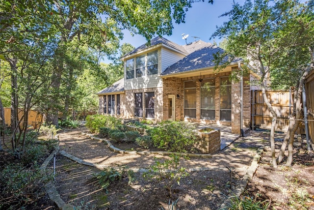 back of property with a sunroom