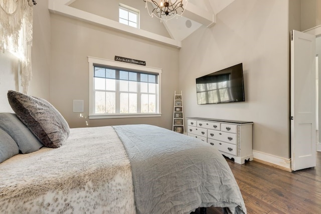 bedroom featuring dark hardwood / wood-style flooring, a chandelier, and high vaulted ceiling