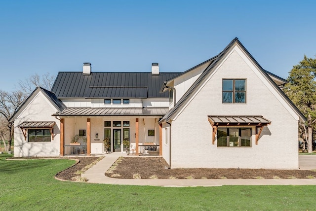 rear view of house featuring a yard