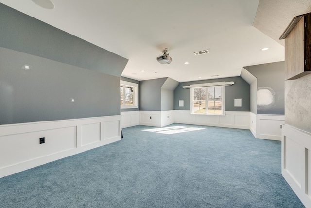 additional living space featuring carpet floors