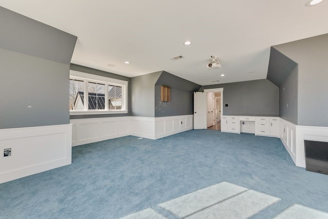 unfurnished living room with lofted ceiling and carpet floors