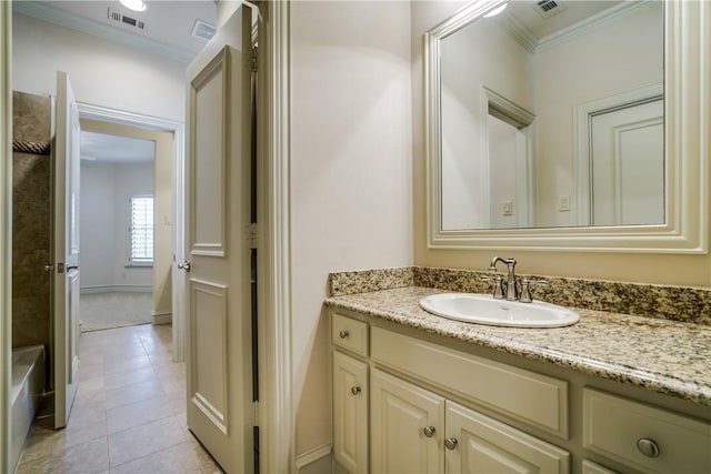 bathroom with tile patterned floors, crown molding, and vanity