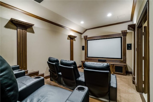 cinema room with decorative columns, light colored carpet, lofted ceiling, and ornamental molding