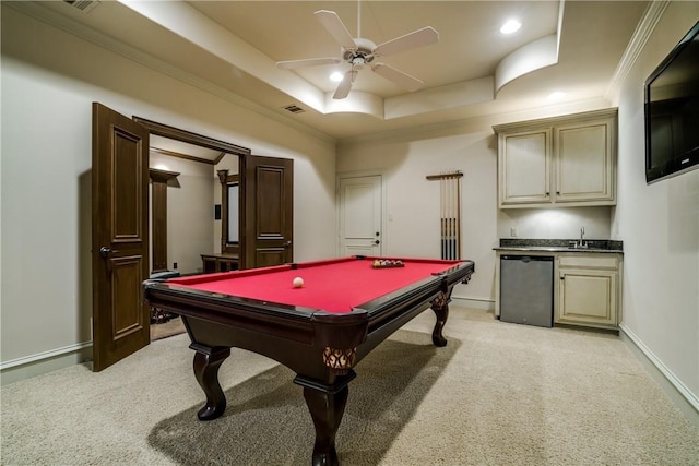 playroom featuring light carpet, a tray ceiling, ceiling fan, wet bar, and pool table