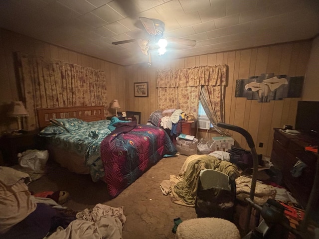 bedroom with ceiling fan and wooden walls