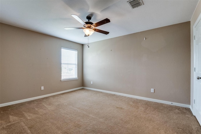 spare room featuring ceiling fan and carpet flooring