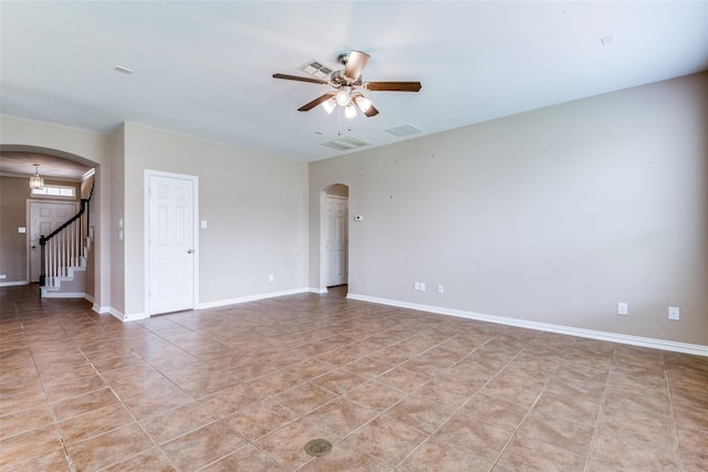 spare room with ceiling fan and light tile patterned flooring