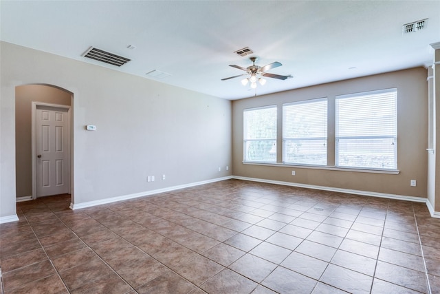 spare room with tile patterned floors and ceiling fan