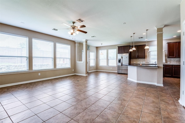 kitchen with ceiling fan, backsplash, stainless steel fridge, pendant lighting, and light tile patterned floors