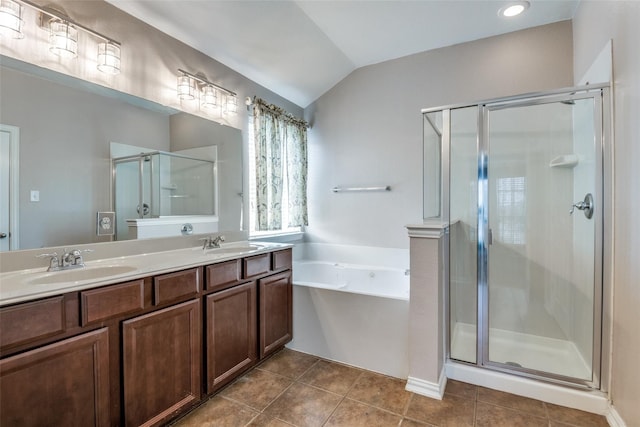 bathroom with tile patterned floors, vanity, separate shower and tub, and lofted ceiling