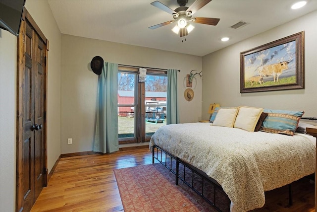 bedroom with access to exterior, light hardwood / wood-style floors, and ceiling fan