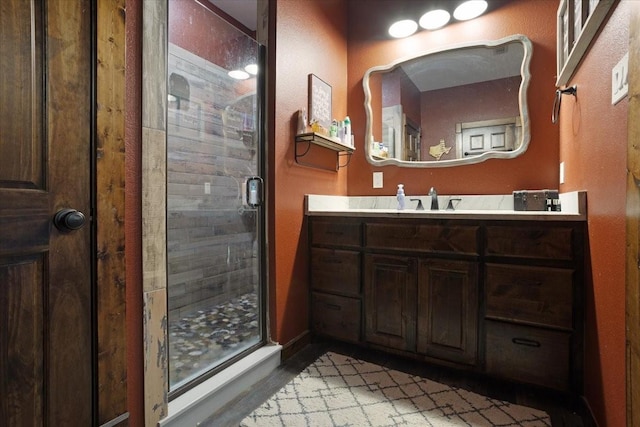 bathroom featuring vanity and a shower with shower door