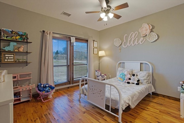 bedroom with light hardwood / wood-style flooring and ceiling fan