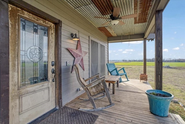 wooden deck with a rural view and ceiling fan