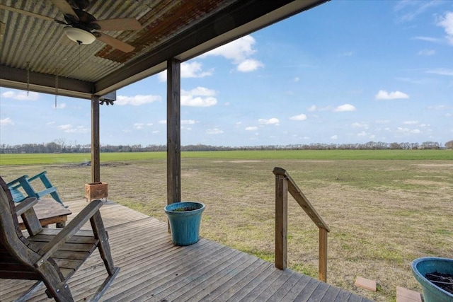 deck with a rural view and ceiling fan