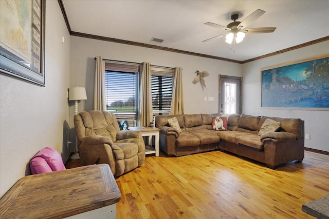 living room featuring hardwood / wood-style floors, crown molding, and ceiling fan