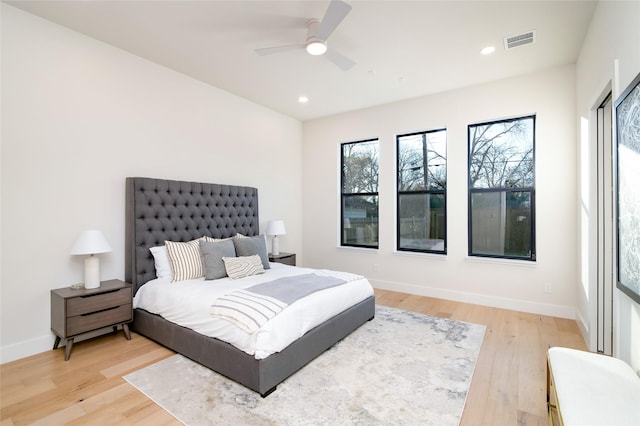 bedroom with light hardwood / wood-style flooring and ceiling fan