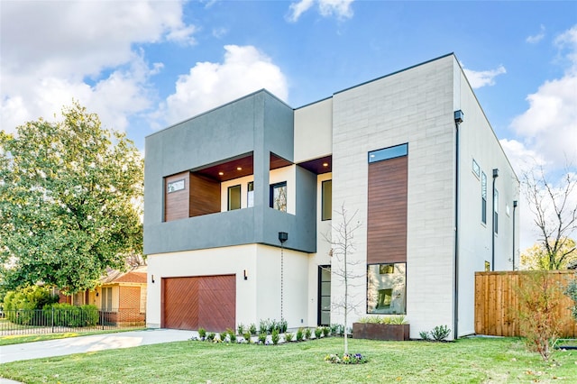 contemporary house with a garage and a front yard