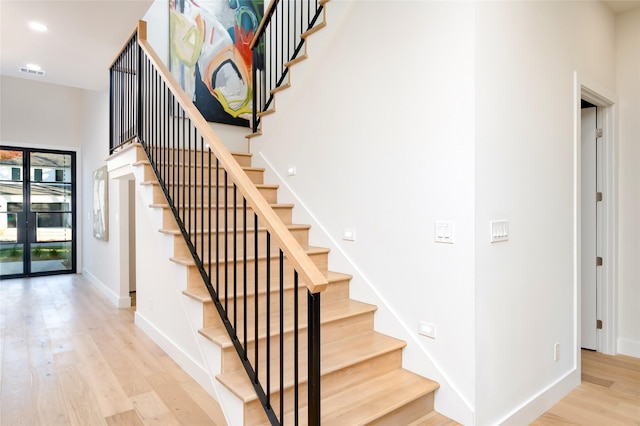 stairway featuring hardwood / wood-style flooring