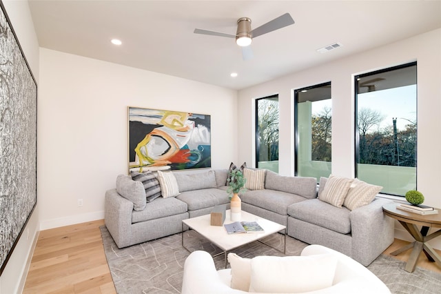 living room featuring ceiling fan and light wood-type flooring