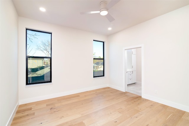 unfurnished room with ceiling fan and light hardwood / wood-style flooring