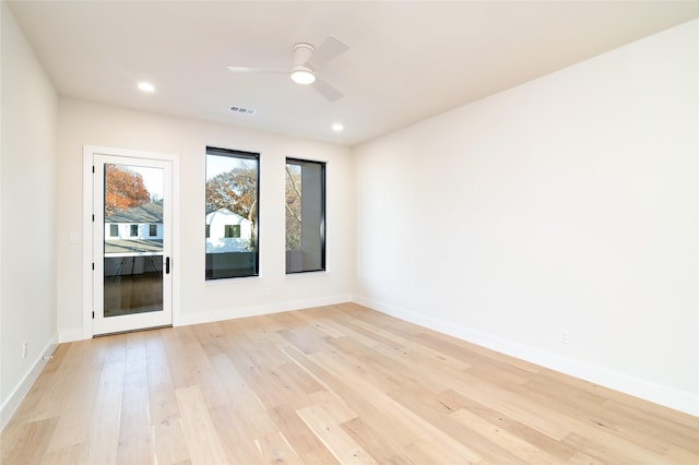 empty room with ceiling fan and light wood-type flooring