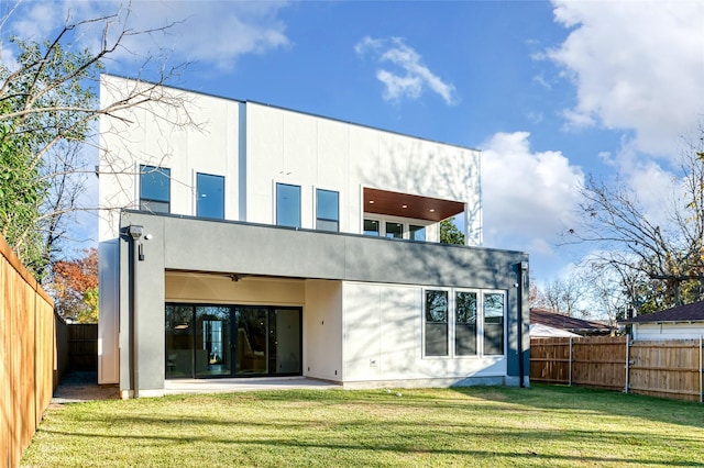 back of house featuring a yard and a patio