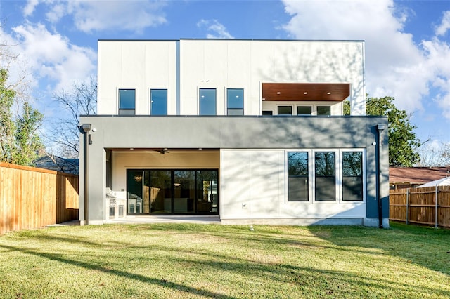 rear view of property featuring a patio area, ceiling fan, and a yard