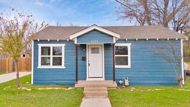 bungalow-style home featuring a front yard