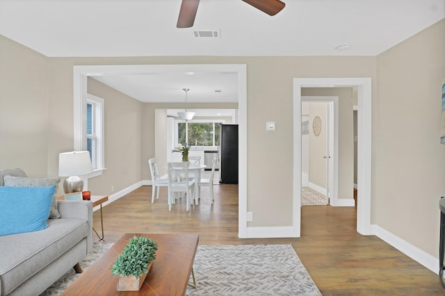 living room with hardwood / wood-style floors and ceiling fan