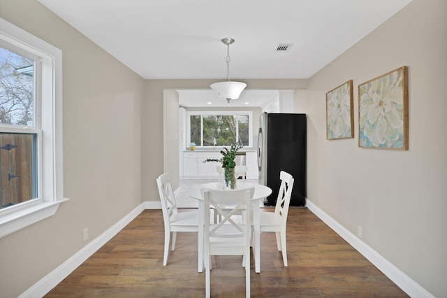 dining area featuring dark hardwood / wood-style flooring